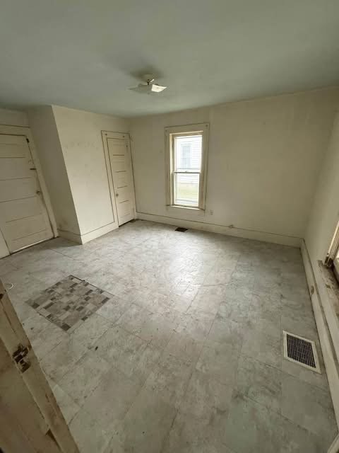 The room after the clean-out: empty floor and clear walls