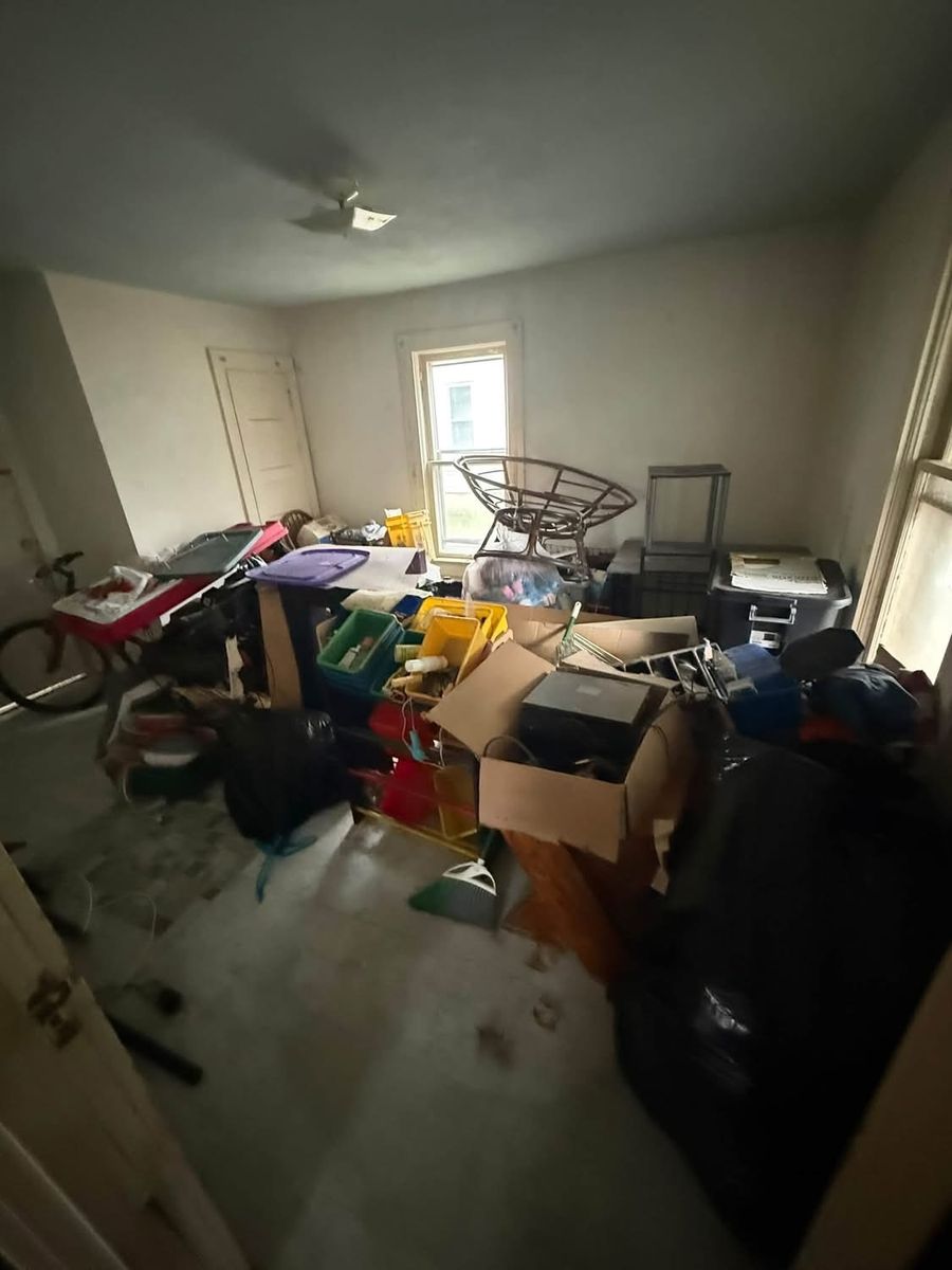 The room before: filled with boxes, bins, and bags